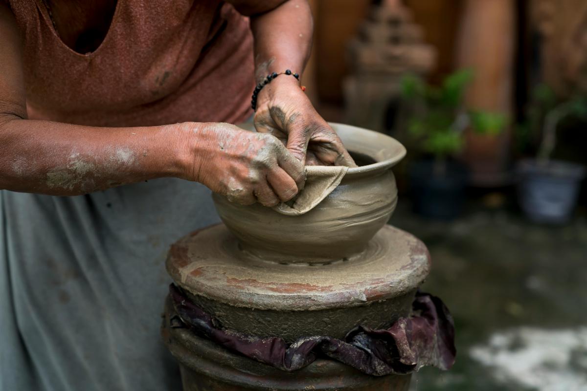 a potter shaping clay into a bowl