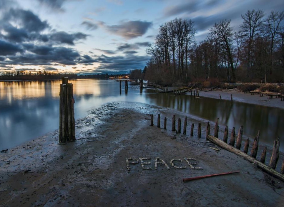 a beautiful nature scene with "PEACE" spelled out in rocks