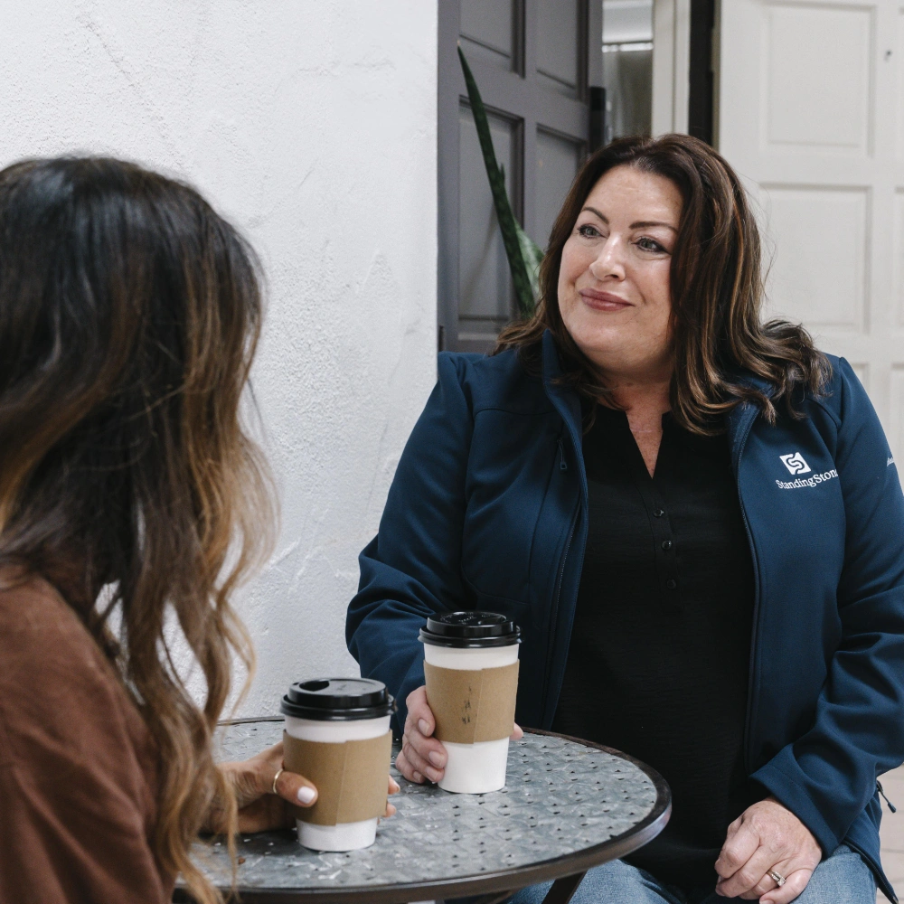 two women drinking coffee